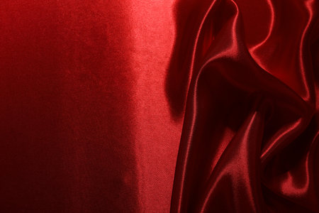 Red crumpled silk fabric as background, top viewの写真素材