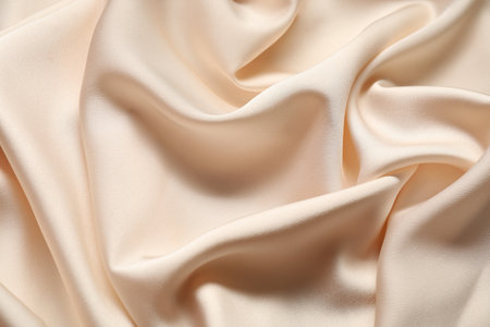 Beige crumpled silk fabric as background, top viewの写真素材