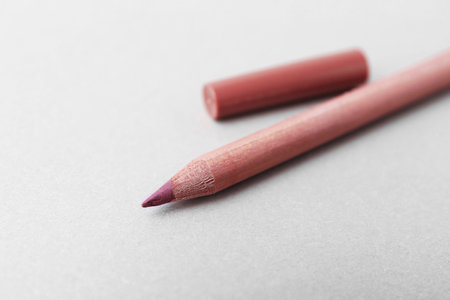 One beautiful lip pencil on light background, closeup. Space for textの写真素材