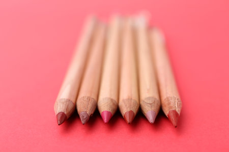 Many different lip pencils on red background, closeupの写真素材