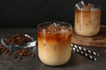 Tasty iced coffee and beans on grey tableの写真素材