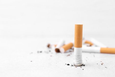 Cigarette butts on light background, selective focus. Space for textの写真素材
