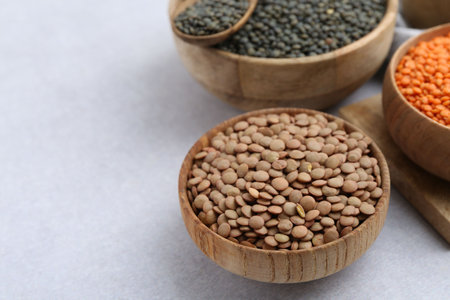 Different types of lentils on light table, closeup. Space for textの写真素材