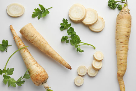 Parsley roots and leaves on white background, flat layの写真素材