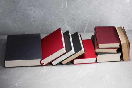 Different old books on light gray marble tableの写真素材