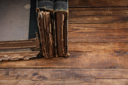 Many old books on wooden table, closeup. Space for textの写真素材
