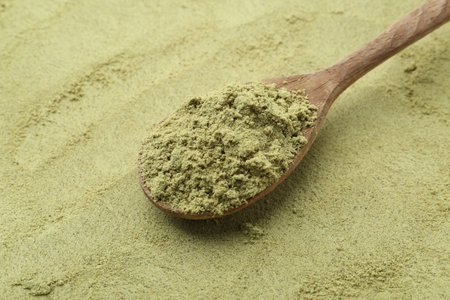 Pumpkin seeds powder and spoon as background, closeupの写真素材