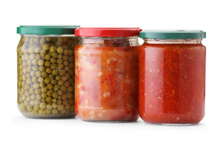 Many jars with different pickled products isolated on whiteの写真素材