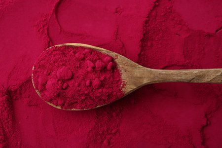 Superfood product. Beetroot powder and spoon as background, closeupの写真素材