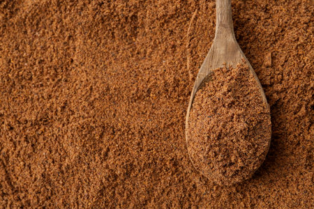 Superfood. Nutmeg powder and spoon, top viewの写真素材
