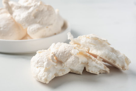Delicious homemade meringue cookies on light table, closeupの写真素材