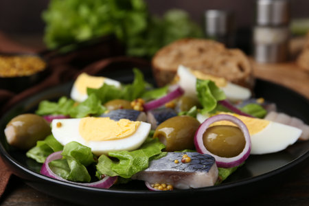 Delicious salad with herring, egg, mustard and vegetables on table, closeupの写真素材