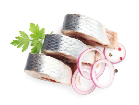 Pieces of delicious herring with spices isolated on white, top viewの写真素材