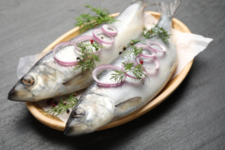 Tasty herrings with spices on black table, closeupの写真素材