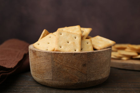 Tasty crackers on wooden table, closeup
