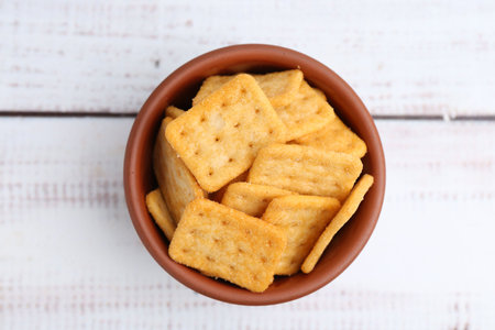 Tasty crackers on white wooden table, top viewの写真素材
