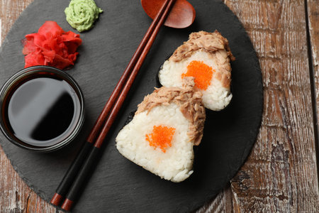 Tasty onigiri (Japanese rice balls) with tuna served on wooden table, top viewの写真素材