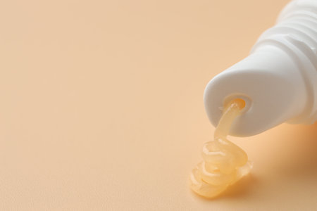 Tube of moisturizing lip balm on beige background, closeup. Space for textの写真素材