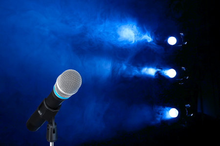 Microphone on stage in smoke under spotlights. Singer's performanceの写真素材