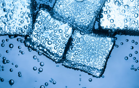 Soda water with ice cubes as background, closeupの写真素材