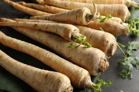 Parsley roots with leaves on black table, closeupの写真素材