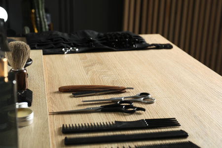 Many different barber's tools on light wooden table in barbershop, closeupの写真素材