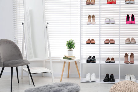 Shoe storage. Shelving unit with different footwear, accessories and mirror indoorsの写真素材
