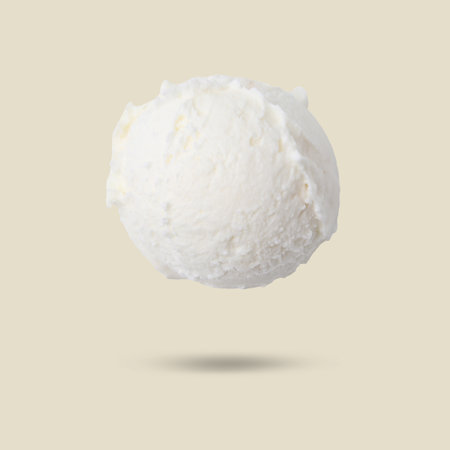 Ice cream scoop in air on beige background. Yummy dessertの写真素材