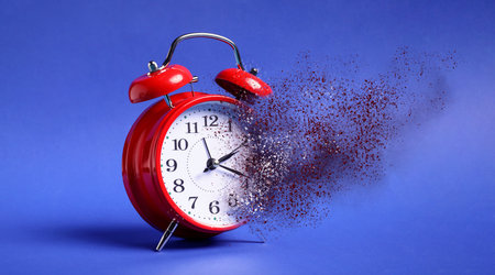 Alarm clock dissolving on blue background. Flow of time