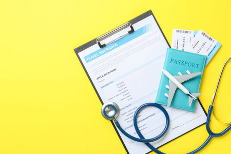 Medical tourism. Travel insurance application form, stethoscope, passport with tickets and airplane...