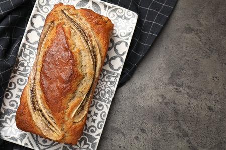 Banana bread on gray table, top view. Space for textの写真素材