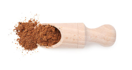 Superfood. Nutmeg powder and scoop isolated on white, top viewの写真素材