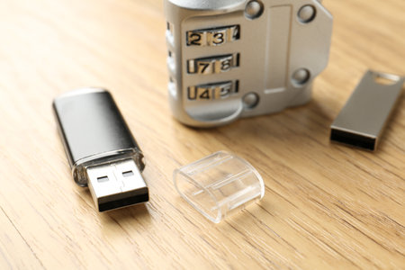 Flash drives and combination padlock on wooden background, closeupの写真素材