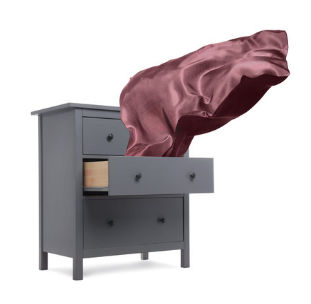 Fabric flying out of dresser on white backgroundの写真素材