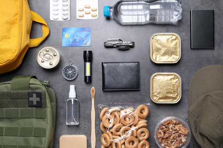Survival kit. Different emergency supplies on grey table, flat layの写真素材