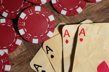 Old vintage playing cards and poker chips on wooden table, flat layの写真素材