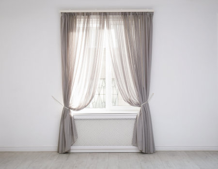 Window with beautiful curtains in empty roomの写真素材