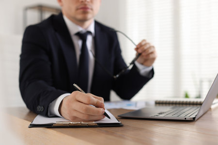 Professional banker working at desk in office, closeupの写真素材