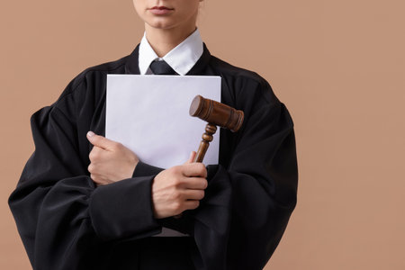 Judge with mallet and documents on light brown background, closeupの写真素材