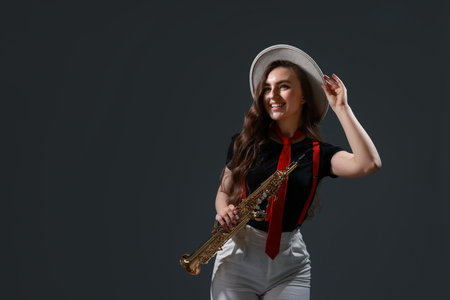 Musician playing soprano saxophone on grey background.の写真素材