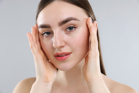 Woman with healthy skin on grey backgroundの写真素材