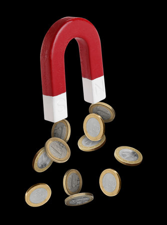 Horseshoe magnet attracting coins on black backgroundの写真素材