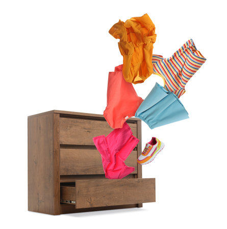 Clothes coming out of dresser on white backgroundの写真素材