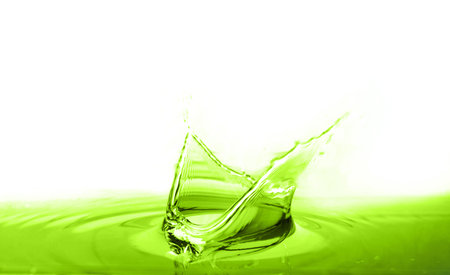 Beautiful green water splashing against white backgroundの写真素材