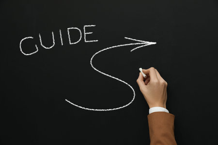 Word Guide and arrow drawn by woman on black chalkboard