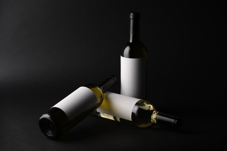 Three bottles of wine on black backgroundの写真素材