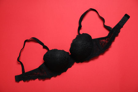 Lace bra on red background, top viewの写真素材