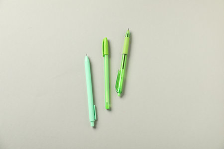 Stylish pens on grey background, flat layの写真素材