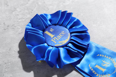 Blue award ribbon on light grey table, closeupの写真素材