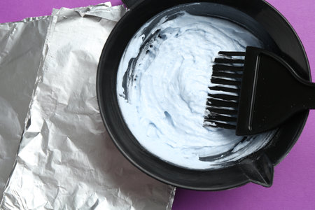 Mixing hair bleaching powder and developer on purple background, closeupの写真素材